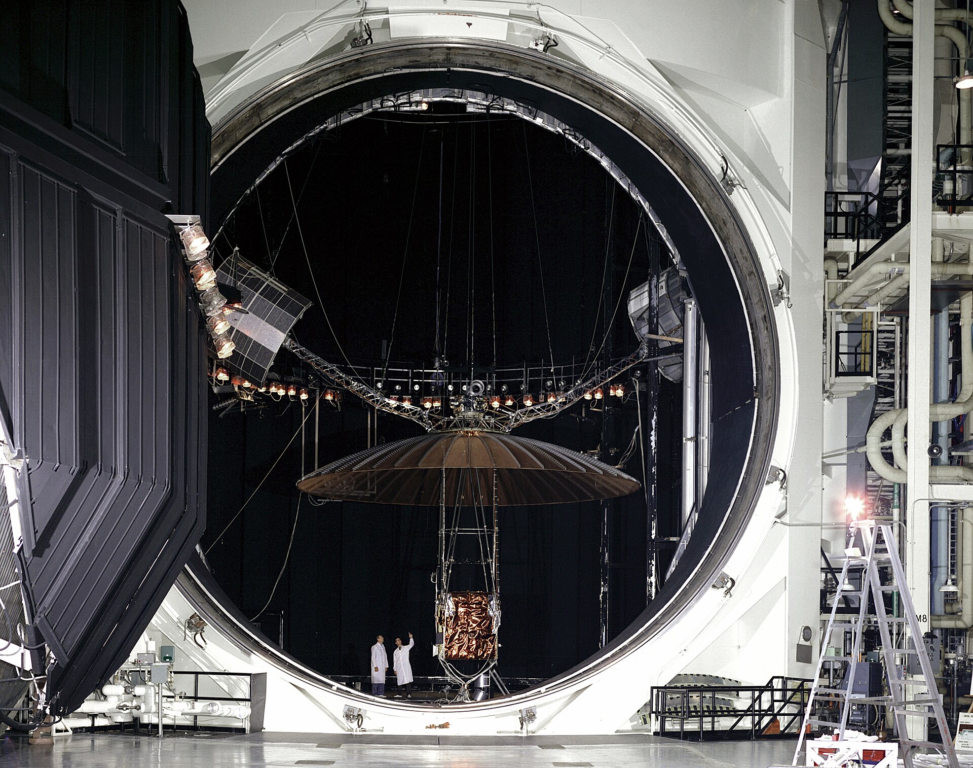 Engineers testing a satellite in a laboratory, an example of hardware tested for reliability