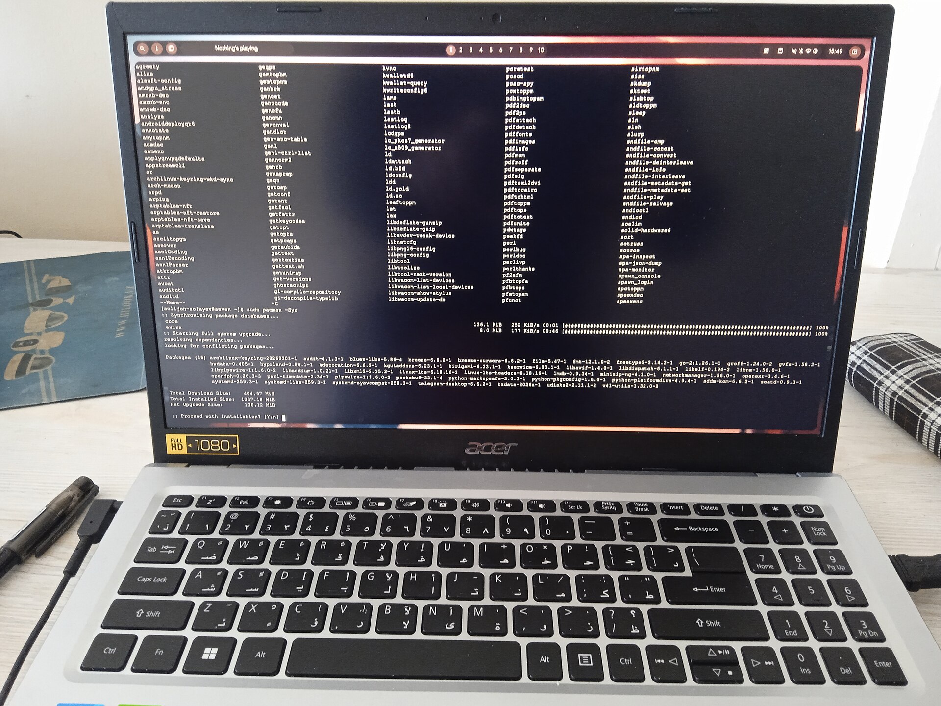 A laptop showing a Linux terminal running a full system update from the command line