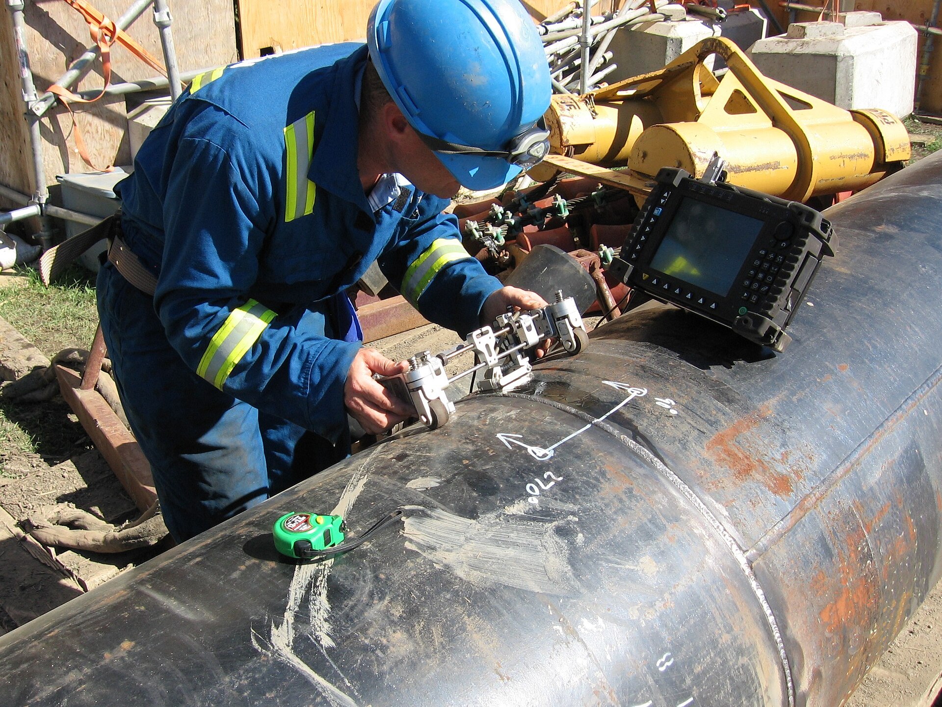 Technicians running an ultrasonic test along a pipeline