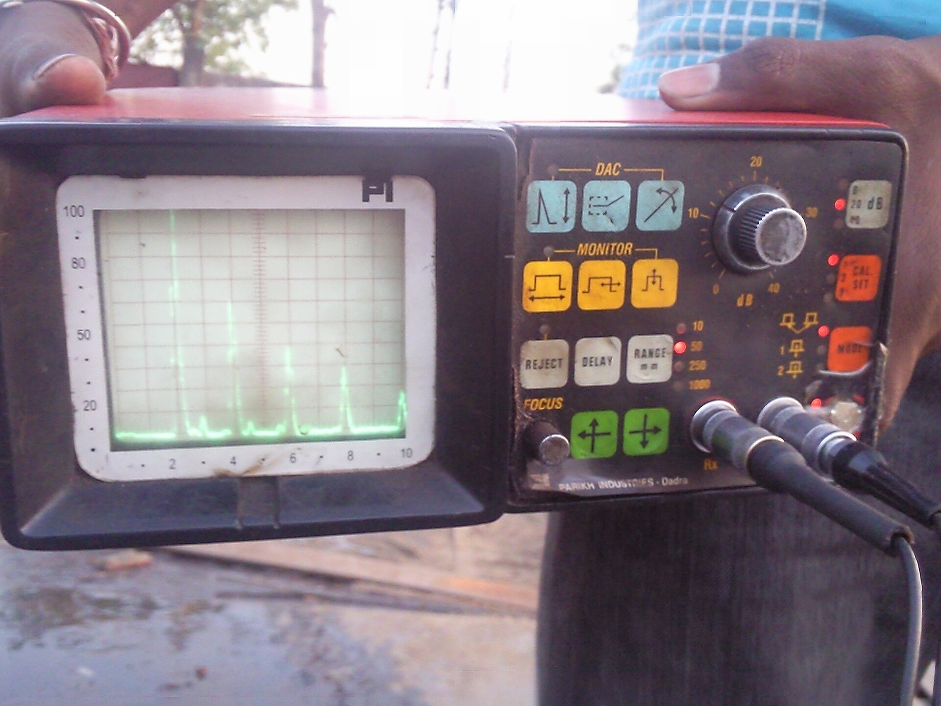 An ultrasonic testing machine showing readings on its display