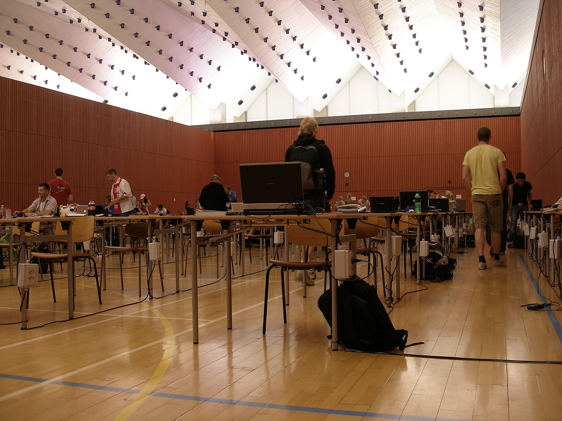 A large examination hall set out with rows of desks